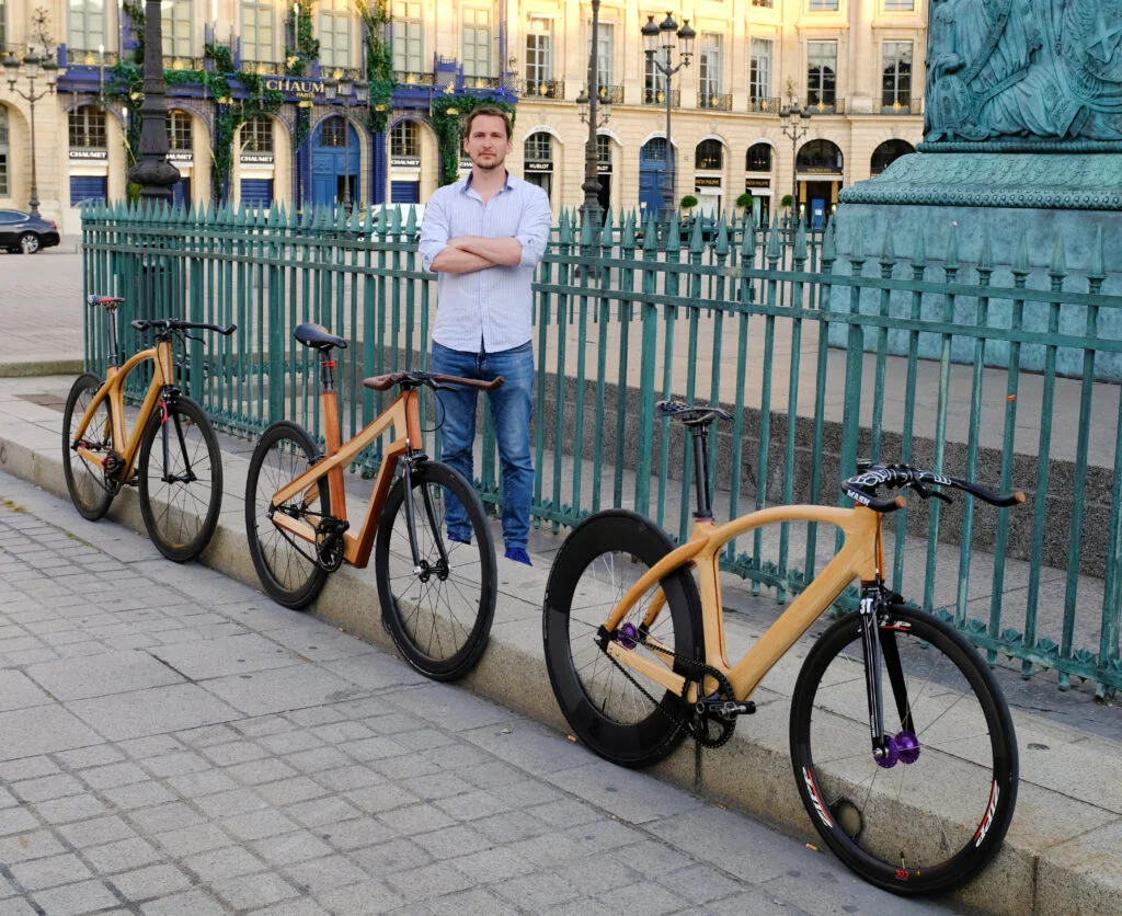 Le créateur Mathieu Houlbert avec trois cadres en bois.